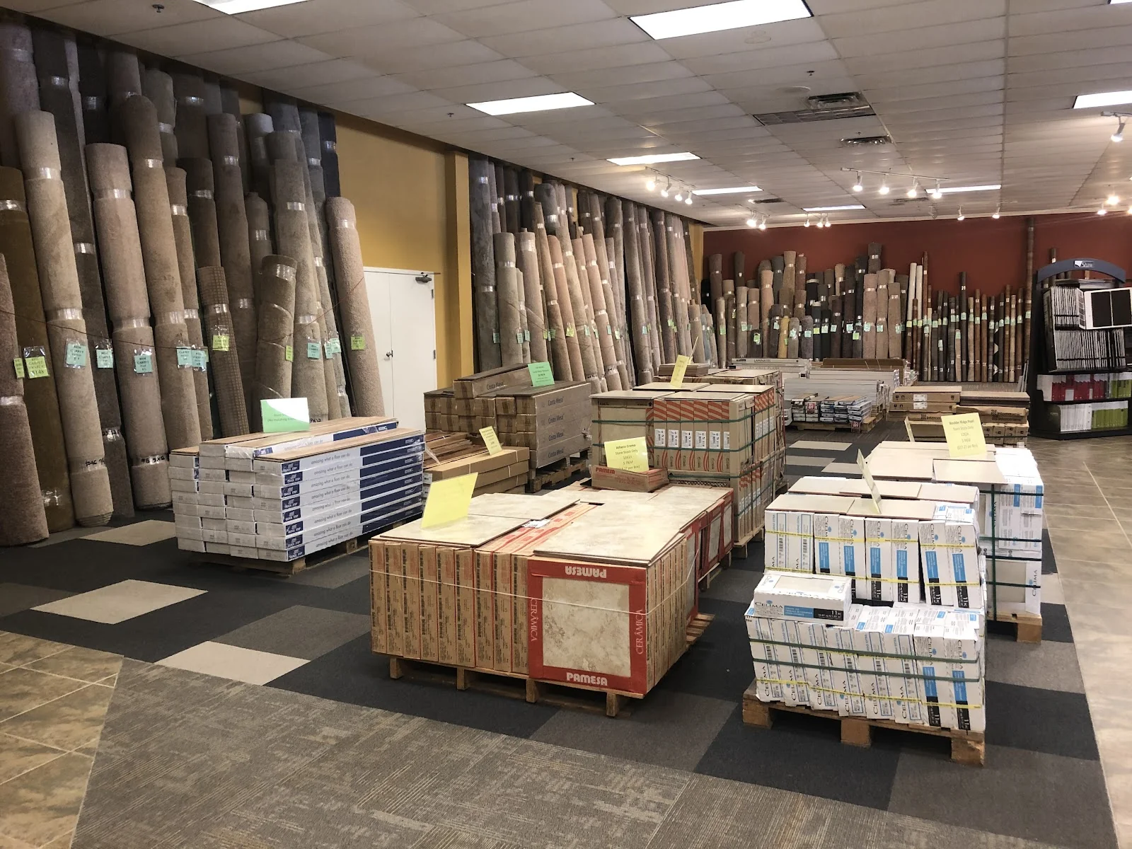 In-stock carpet rolls and tile pallets in the Carpet To Go Flooring warehouse