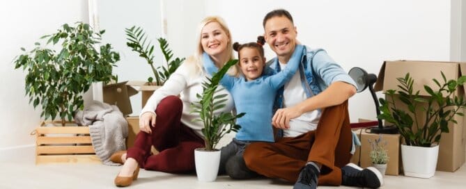 Happy family sitting on the wooden floor